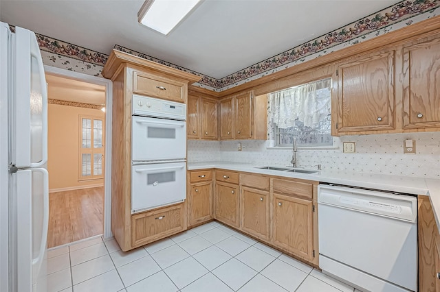 kitchen with sink, white appliances, light tile patterned floors, and backsplash