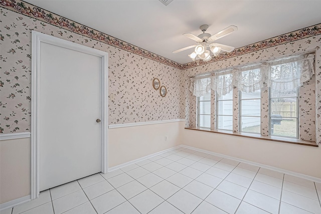 empty room featuring light tile patterned floors and ceiling fan