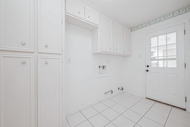 washroom with gas dryer hookup, cabinets, washer hookup, and light tile patterned flooring