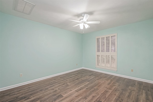 empty room with dark hardwood / wood-style floors and ceiling fan