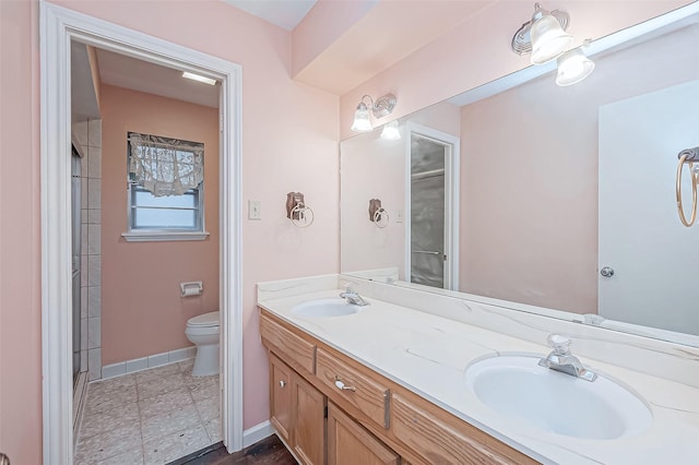 bathroom featuring tile patterned flooring, vanity, and toilet