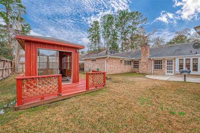 view of yard with a wooden deck and a patio