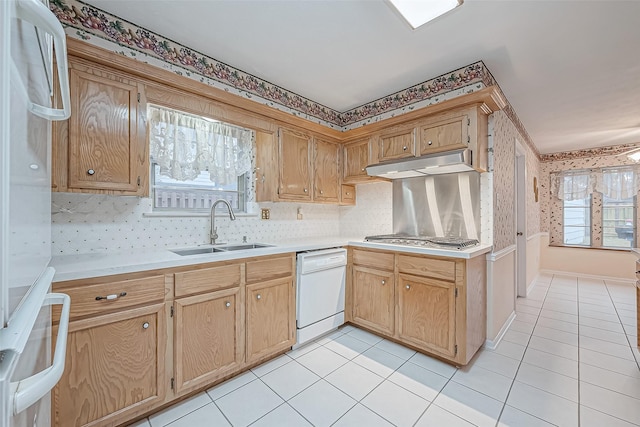 kitchen with sink, light tile patterned floors, stainless steel gas stovetop, and dishwasher