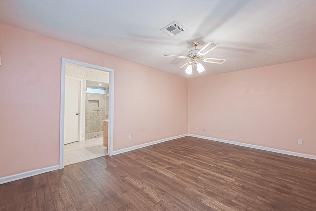 spare room featuring hardwood / wood-style flooring and ceiling fan