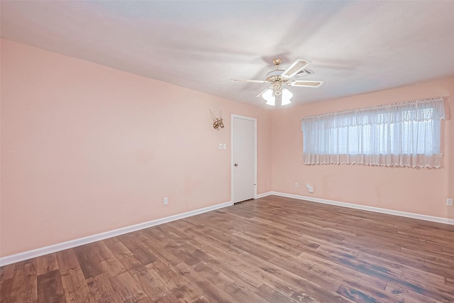 empty room featuring hardwood / wood-style floors and ceiling fan