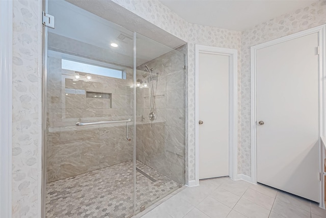 bathroom with tile patterned floors and an enclosed shower