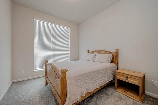 carpeted bedroom featuring baseboards