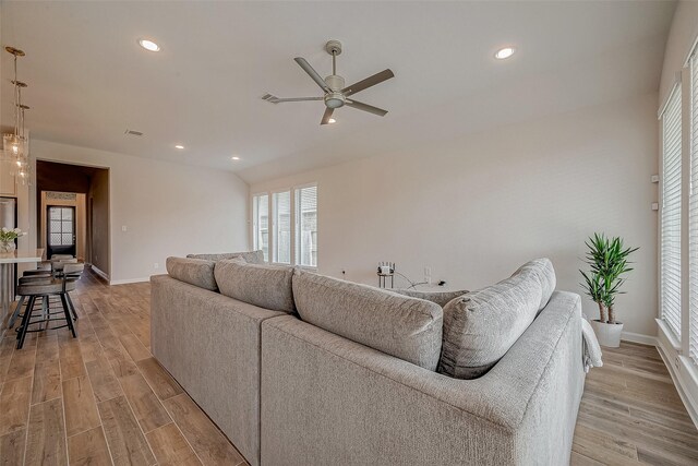 living room featuring light hardwood / wood-style floors and ceiling fan