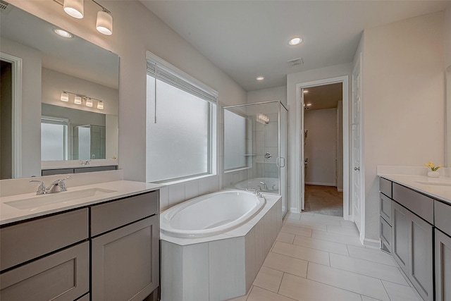 bathroom with shower with separate bathtub, tile patterned floors, and vanity