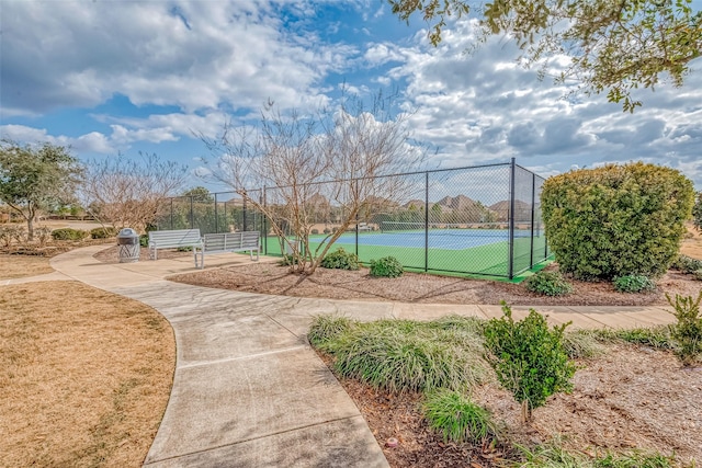 view of sport court with a gate and fence