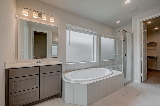 full bathroom featuring a garden tub, a shower stall, visible vents, and vanity