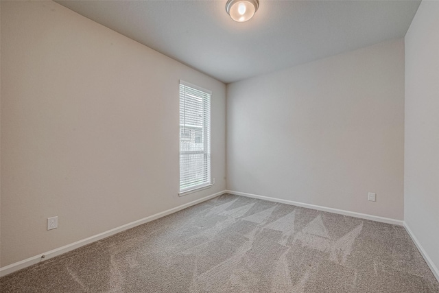 empty room with carpet and baseboards