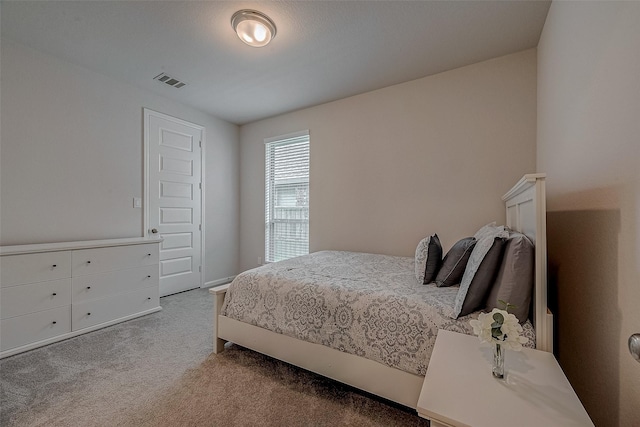 bedroom featuring carpet floors and visible vents