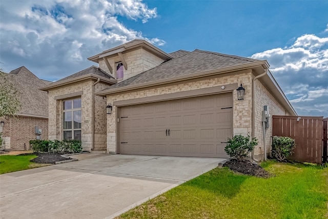 view of front of house featuring a garage and a front lawn