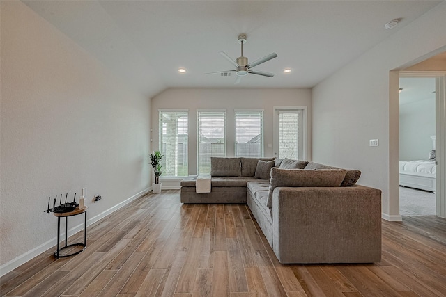 living room with vaulted ceiling, ceiling fan, and light hardwood / wood-style floors