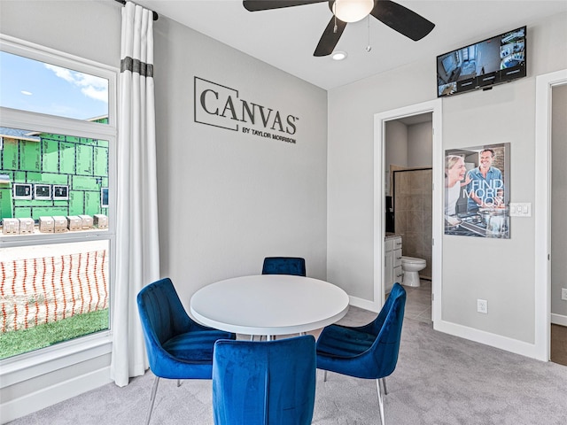 dining space with ceiling fan, light carpet, and a wealth of natural light