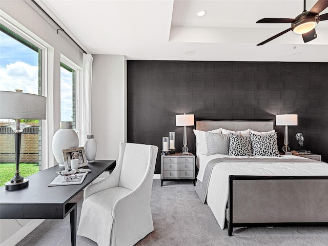 bedroom featuring light colored carpet and ceiling fan