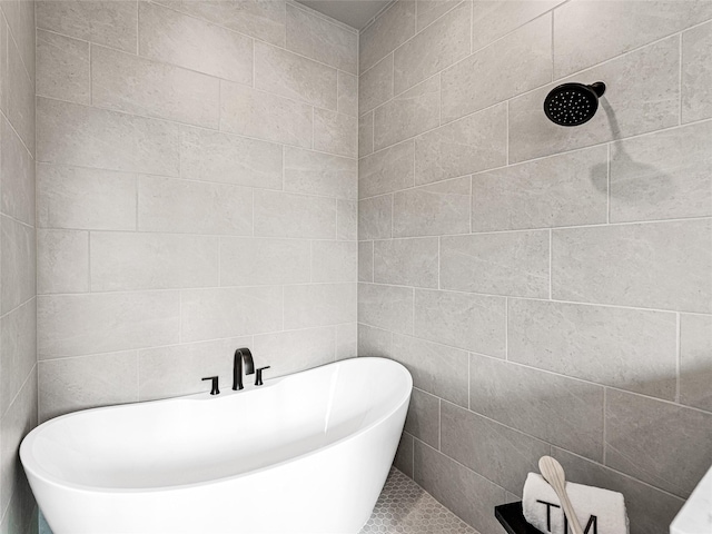 bathroom with a washtub and tile walls