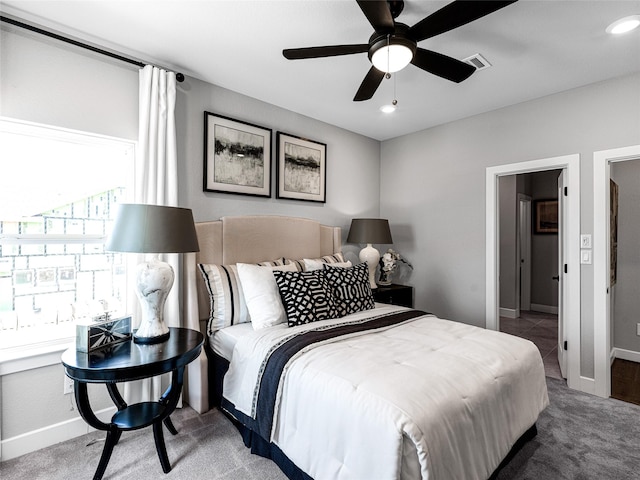 bedroom featuring ceiling fan and carpet