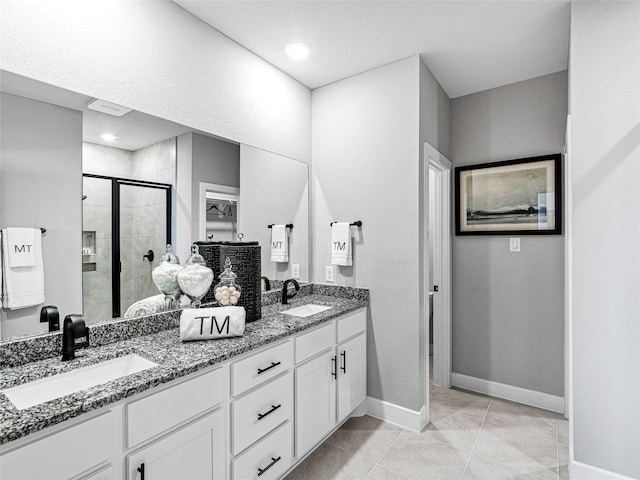 bathroom featuring walk in shower, vanity, and tile patterned flooring