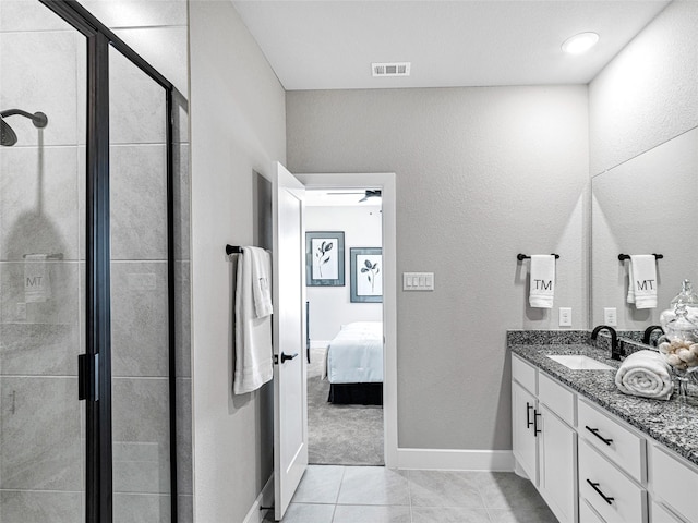 bathroom featuring an enclosed shower, vanity, and tile patterned floors