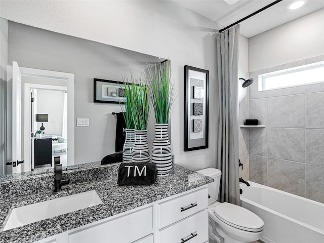 full bathroom with vanity, toilet, and shower / bath combo with shower curtain