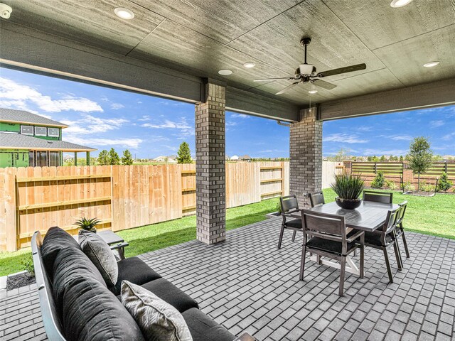 view of patio with an outdoor living space and ceiling fan