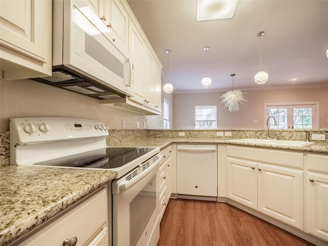 kitchen featuring crown molding, sink, white appliances, and decorative light fixtures