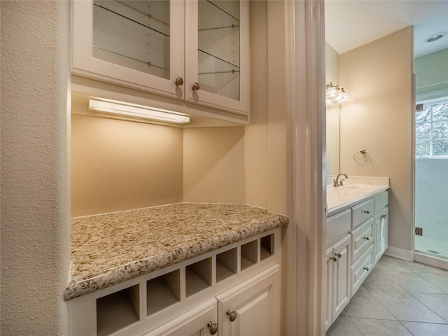 bathroom with tile patterned floors and vanity