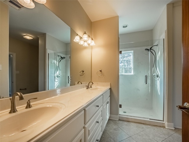 bathroom featuring vanity, tile patterned flooring, and a shower with shower door