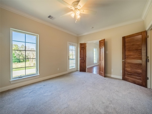 unfurnished bedroom featuring multiple windows, ornamental molding, and light colored carpet