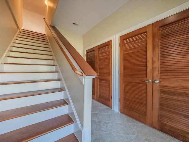 stairs with tile patterned floors