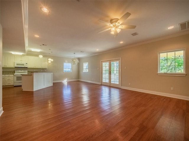 unfurnished living room with hardwood / wood-style floors, crown molding, french doors, and ceiling fan