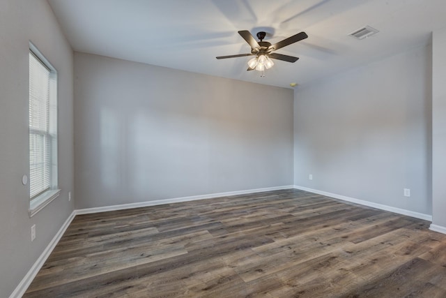 spare room with dark hardwood / wood-style floors and ceiling fan