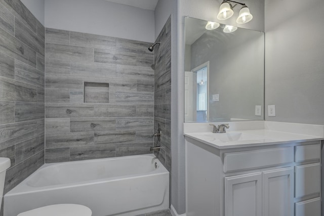 full bathroom featuring vanity, toilet, and tiled shower / bath