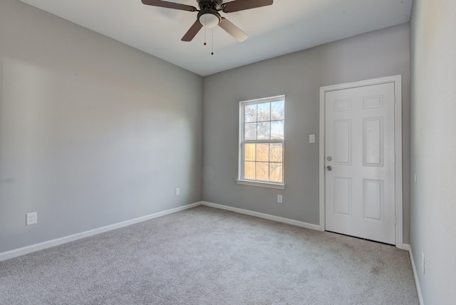 carpeted empty room featuring ceiling fan