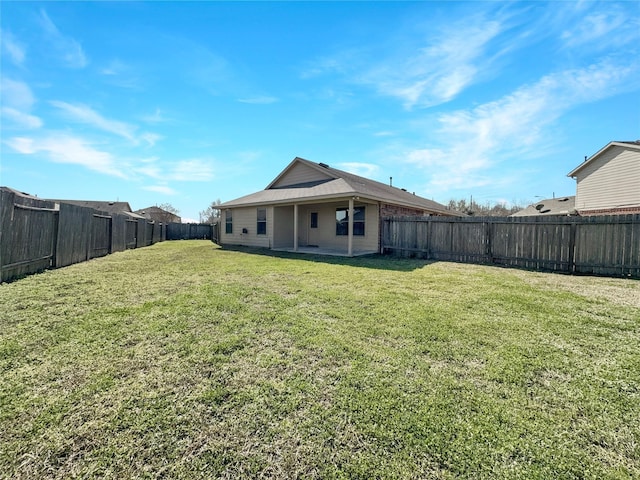 rear view of house featuring a yard