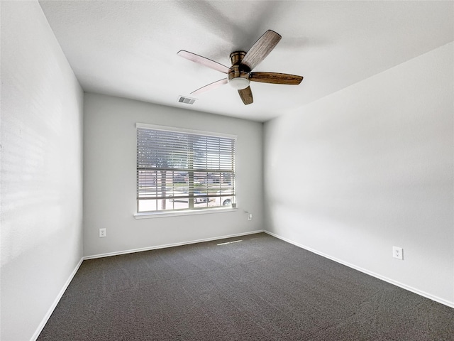 unfurnished room featuring dark colored carpet and ceiling fan