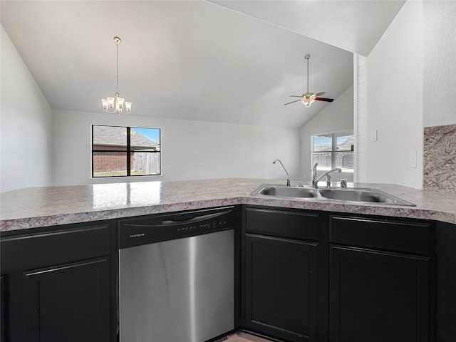 kitchen featuring lofted ceiling, sink, ceiling fan with notable chandelier, stainless steel dishwasher, and kitchen peninsula