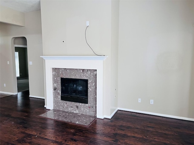 interior details featuring hardwood / wood-style floors and a tile fireplace