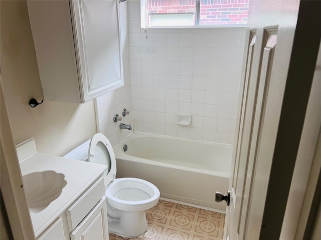 full bathroom with vanity, tiled shower / bath combo, and toilet