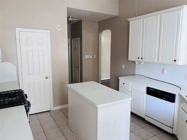 kitchen featuring white dishwasher, light tile patterned floors, a kitchen island, and white cabinets