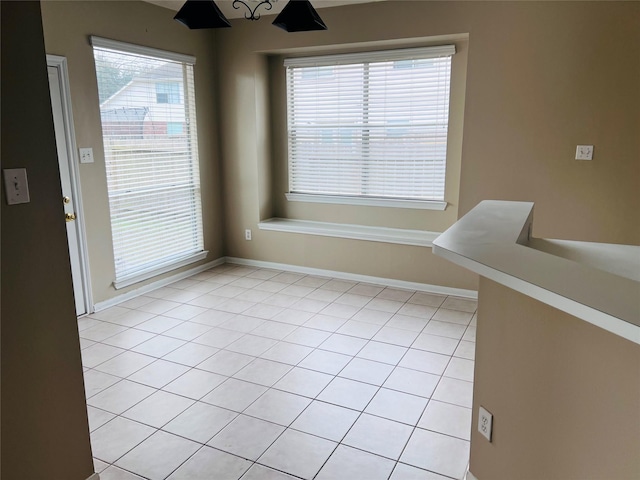 unfurnished dining area featuring light tile patterned flooring