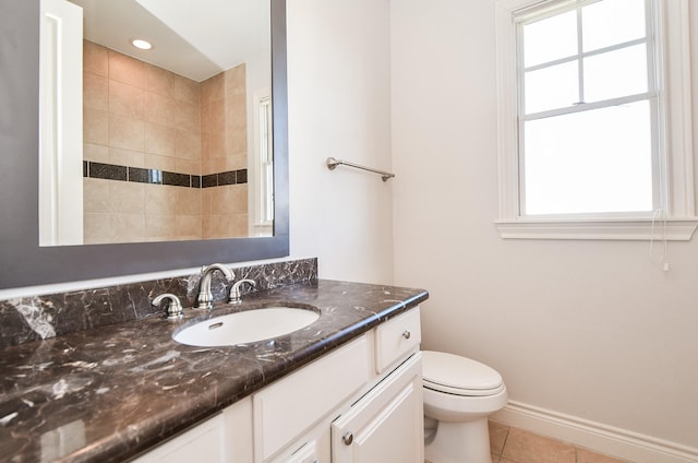 bathroom with tile patterned flooring, vanity, and toilet