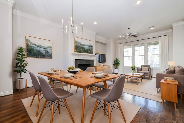 dining room featuring ornamental molding, dark hardwood / wood-style floors, and a tile fireplace