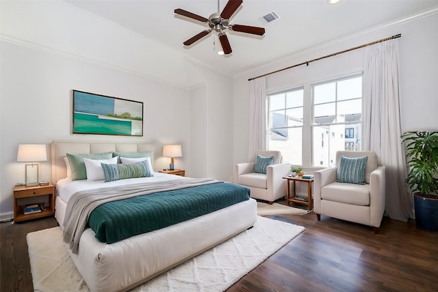 bedroom featuring dark hardwood / wood-style flooring, crown molding, and ceiling fan