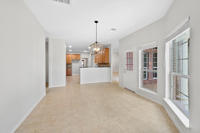 interior space with light tile patterned floors and a notable chandelier