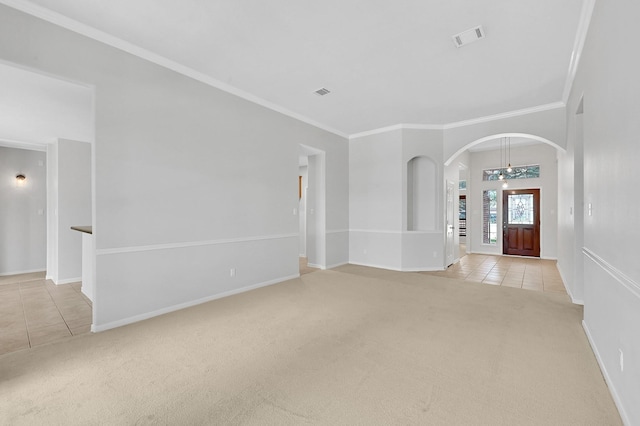 unfurnished living room featuring ornamental molding and light carpet