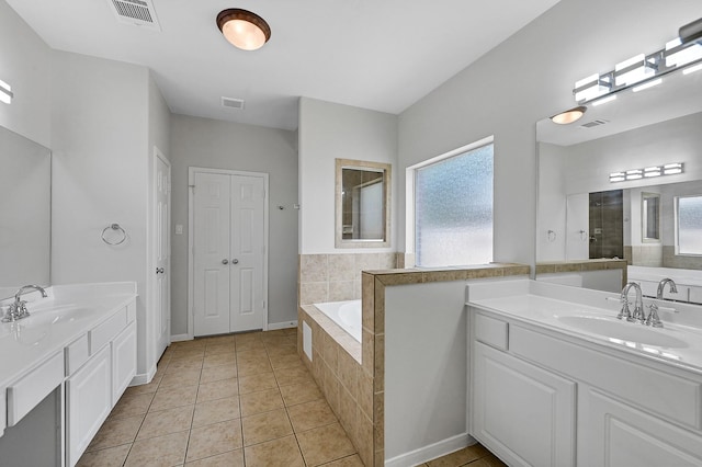 bathroom with tile patterned floors, plus walk in shower, and vanity