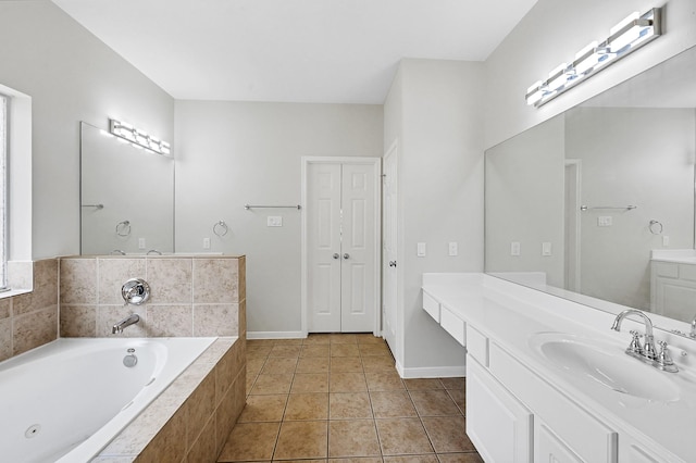 bathroom featuring vanity, tiled bath, and tile patterned flooring